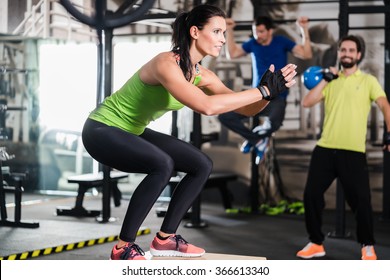 Group Of Men And Woman In Functional Training Gym Doing Fitness Exercise