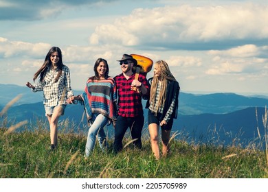 Group Of Men And Women Hiking. Group Of People Friends Enjoy Outdoor Lifestyle Activity In Nature Hiking And Camping Together On The Mountain.