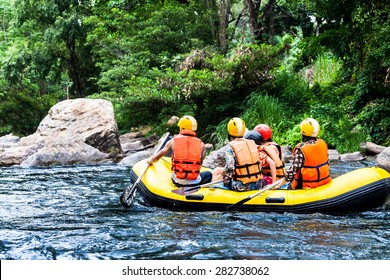 A group of men and women are rafting on the river, extreme and fun sport