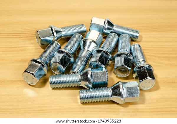 A group of\
metal bolts securing a car\
wheel.