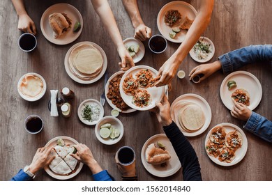 Group of Mexican People eating Tacos al Pastor in a Taqueria in Mexico, Tacos top view - Powered by Shutterstock