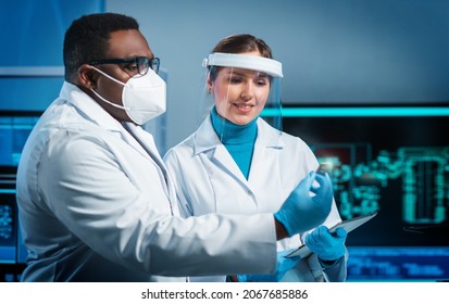 Group of microelectronic engineers discussing in a modern microprocessor manufacture lab. Workplace of electronics designers. The concept of innovations and inventions. - Shutterstock ID 2067685886