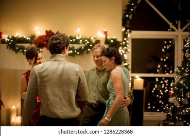Group of mid-adult friends having fun at a Christmas party. - Shutterstock ID 1286228368