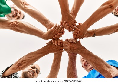 Group of middle age friends with hands together.