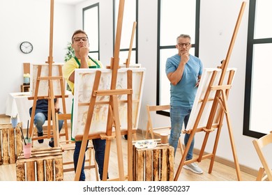 Group Of Middle Age People Artist At Art Studio Serious Face Thinking About Question With Hand On Chin, Thoughtful About Confusing Idea 