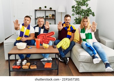 Group Of Middle Age People Wearing Team Scarf Cheering Football Game With Open Hand Doing Stop Sign With Serious And Confident Expression, Defense Gesture 