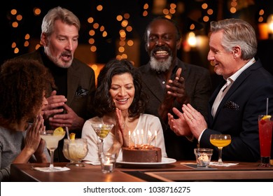 Group Of Middle Aged Friends Celebrating Birthday In Bar