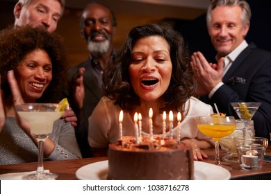 Group Of Middle Aged Friends Celebrating Birthday In Bar