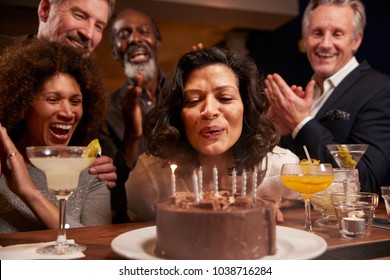 Group Of Middle Aged Friends Celebrating Birthday In Bar