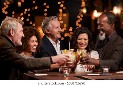 Group Of Middle Aged Friends Celebrating In Bar Together