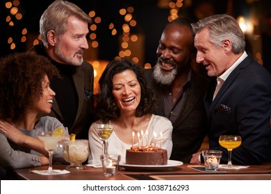 Group Of Middle Aged Friends Celebrating Birthday In Bar