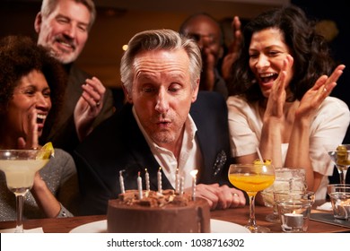 Group Of Middle Aged Friends Celebrating Birthday In Bar