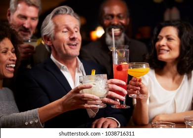 Group Of Middle Aged Friends Celebrating In Bar Together