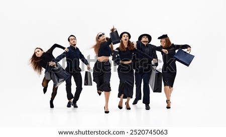 Group in mid-motion, with some pointing forward as if heading toward something important against white studio background. Concept of shopping, Black Friday, fashion and style, sale season. Ad