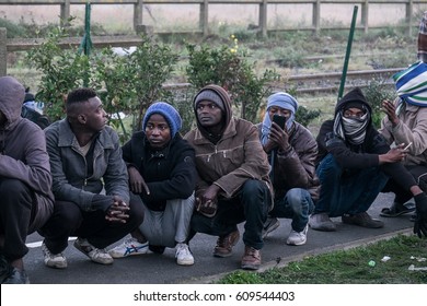 A Group Of Migrants And Refugees Wait To Leave The Jungle Camp, Calais, France. November 2016.