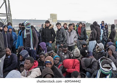 A Group Of Migrants And Refugees Wait To Leave The Jungle Camp, Calais, France. November 2016.