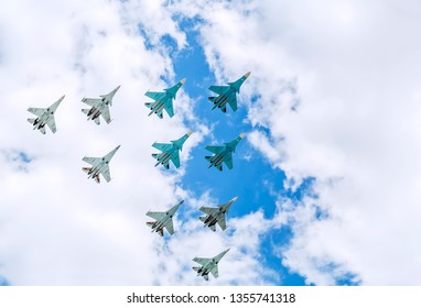 A group of military aircraft flying in the cloudy sky during an air show - Powered by Shutterstock