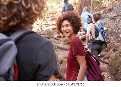 Group Of Millennial  Friends Hiking Uphill On A Forest Trail, Waist Up