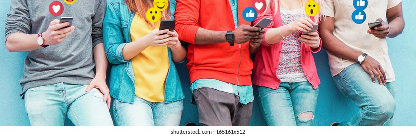Group of millennial friends using mobile phones - Young people addiction to technology trends following and chatting with emoji on smartphones - Tech and millennial concept - Focus on center hands