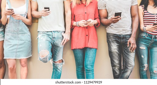 Group of millennial friends watching smart mobile phones - Teenagers addiction to new technology trends - Concept of youth, tech, social and friendship - Focus on smartphones hands