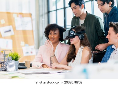 group of millennial male and female multiethnic using vr goggle to test metaverse meeting system cheerful and smiling,office friend standing discussion together next to window office background - Powered by Shutterstock