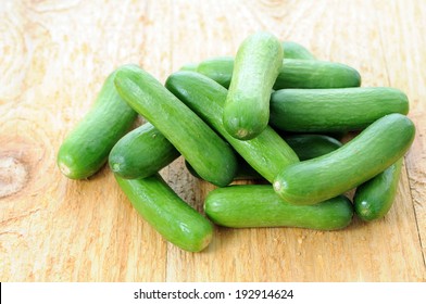 A Group Mini Cucumbers On Wooden Board 