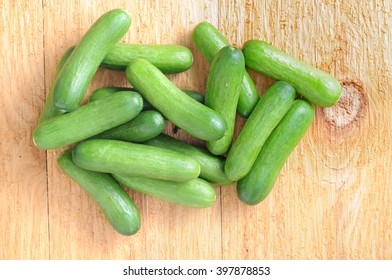 A Group Mini Cucumbers On Wooden Board 