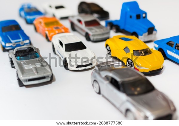The group of miniature car toy on\
the road. Traffic jam concept with multiple toy cars on a white\
background.pollution.global warming,co2\
concept.