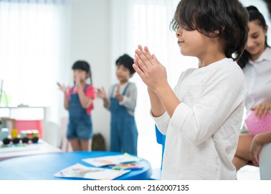 Group Of Mixed Race Cute Child Standing Clapping Hands In Classroom. Student Young Little Kid Boy Applaud To Answer Questions In Schoolroom Enjoy To Study With Smiling, Feel Glad And Proud At School.