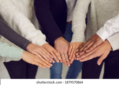 Group Of Mixed Race People Joining Hands As Symbol Of Team Spirit. Concept Of Power, Unity, Corporate Social Responsibility, Mutual Support And Reaching Goals Together. Human Hands In Close-up