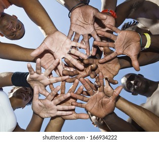 A group of mixed race people putting hands together
