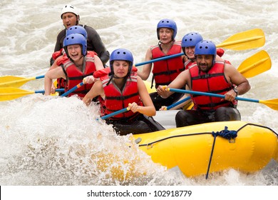 Group Of Mixed Tourist Man And Woman With Guided By Professional Pilot On Whitewater River Rafting In Ecuador