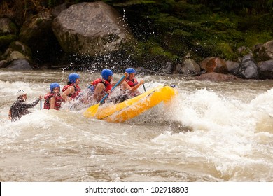 Group Of Mixed Tourist Man And Woman With Guided By Professional Pilot On Whitewater River Rafting In Ecuador