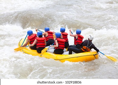 Group Of Mixed Tourist Man And Woman With Guided By Professional Pilot On Whitewater River Rafting In Ecuador