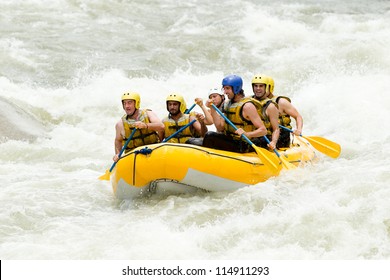 Group Of Mixed Tourist Man And Woman With Guided By Professional Pilot On Whitewater River Rafting In Ecuador