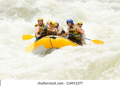 Group Of Mixed Tourist Man And Woman With Guided By Professional Pilot On Whitewater River Rafting In Ecuador