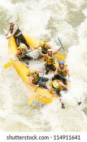 Group Of Mixed Tourist Man And Woman With Guided By Professional Pilot On Whitewater River Rafting In Ecuador