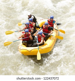 Group Of Mixed Tourist Man And Woman With Guided By Professional Pilot On Whitewater River Rafting In Ecuador