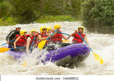 Group Of Mixed Tourist Man And Woman With Guided By Professional Pilot On Whitewater River Rafting In Ecuador