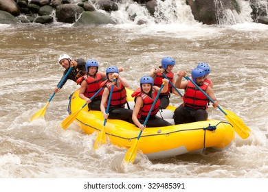 Group Of Mixed Tourist Man And Woman With Guided By Professional Pilot On Whitewater River Rafting In Ecuador