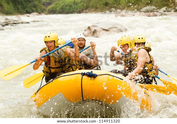 Group Of Mixed\
Tourist Man And Woman With Guided By Professional Pilot On\
Whitewater River Rafting In\
Ecuador