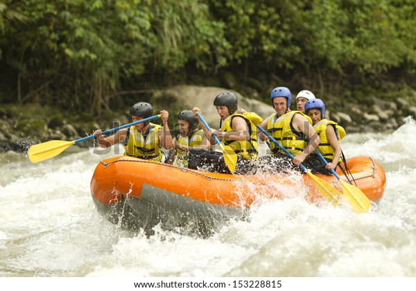 Group Of Mixed\
Tourist Man And Woman With Guided By Professional Pilot On\
Whitewater River Rafting In\
Ecuador