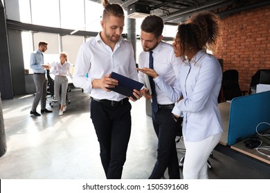 Group Of Modern Business People Are Talking And Smiling While Standing In The Office Hallway