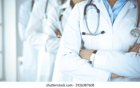 Group of modern doctors standing as a team with arms crossed in hospital office. Medical help, insurance in health care, best desease treatment and medicine concept - Shutterstock ID 1926387608