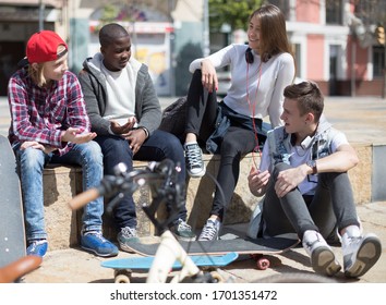 Group Of Modern Teens Talking In The Yard