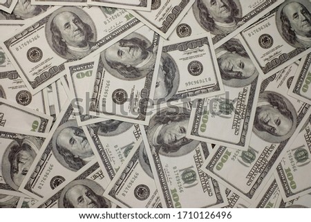 Group of money stack of 100 US dollars banknotes a lot of the background texture top view