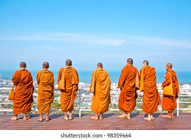 Group monk standing on the view point of HuaHin mountain - Powered by Shutterstock