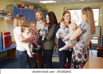 Group Of Mothers With Babies Meeting At Playgroup