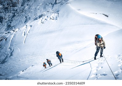 A group of mountaineers climbing Everest, Nepal. Everest is the highest mountain on the planet