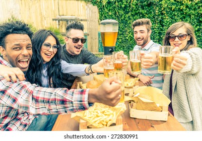 Group Of Mult-ethnic Friends Toasting Beer Glasses - Happy People Partying And Eating In Home Garden - Young Active Adults In A Picnic Area With Burgers And Drinks